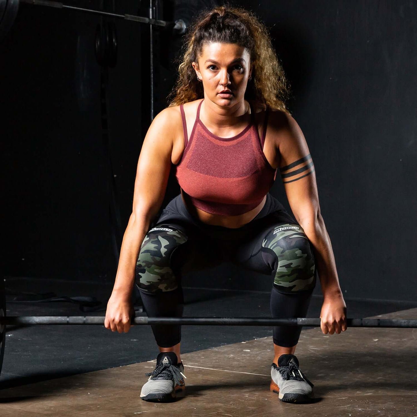 Woman lifting crossfit camo knee sleeves